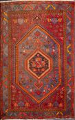 A Hamadan rug, the hexagonal hooked field with a hexagonal stellar pole medallion,