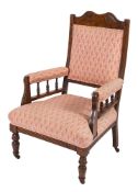 A late Victorian stained upholstered easy chair, with sprung seat,