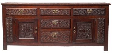 An oak dresser base, early 18th century and later carved; the top,