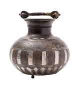 A Middle Eastern white-metal and copper inlaid bronze vessel with swing handle,
