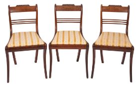 A set of three Regency rosewood sidechairs, circa 1815; the backrests with gadrooned toprails,
