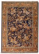 A Kashmiri rug, the indigo field with equestrian hunting figures and trees and flowers,