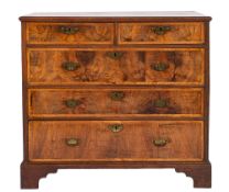 A George II walnut chest of drawers, mid 18th century; the top with moulded edges,