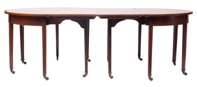 A late George III mahogany extending dining table,
