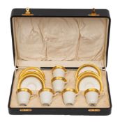 A Royal Worcester porcelain coffee set comprising six cups and six saucers each with tooled gilt