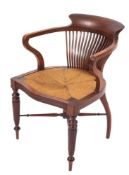 An Edwardian mahogany office desk armchair in the manner of Shoolbred, of tub-shaped outline,