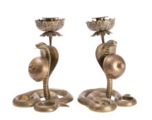A pair of unusual Indian brass snake combination table bell/candlesticks each in the form of a