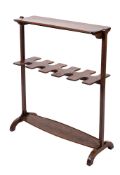 A 19th Century mahogany boot rack surmounted by a rectangular shelf,
