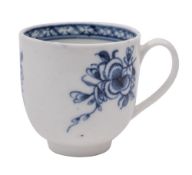A Bristol blue and white coffee cup painted with floral sprays and an interior lattice border,