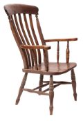 A Victorian oak and elm lath back elbow chair,