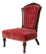 A Victorian carved walnut and pink velvet button upholstered nursing chair,