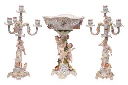 An early 20th Century Meissen-style porcelain figural centrepiece and a pair of similar four-light