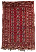 A Turkoman rug, the red field with three rows of quartered guls,