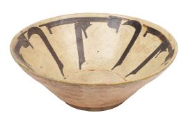 A Kashan pottery bowl of conical form and set on a shallow foot the ivory glazed interior with a