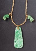 A jade pendant, carved in the form of a bunch of gourds, with two charms in the form of monkeys,