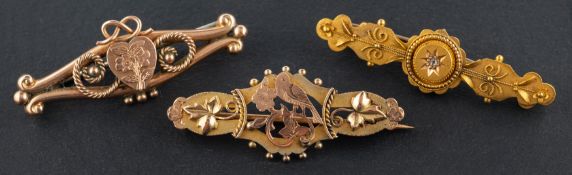Three Victorian, gold brooches, including an Etruscan Revival diamond brooch,