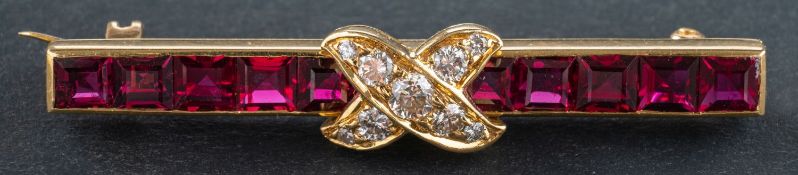 A calibre-cut ruby and round, brilliant-cut diamond bar brooch, total estimated diamond weight ca.