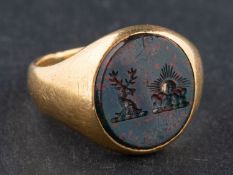 A Victorian, 18ct gold, bloodstone signet ring, engraved with heraldic device,