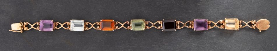 An octagonal, step-cut, vari-coloured gemset bracelet, including citrine, garnet,