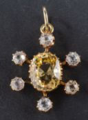 An oval, mixed-cut, synthetic, yellow sapphire and round, mixed-cut, probably synthetic,