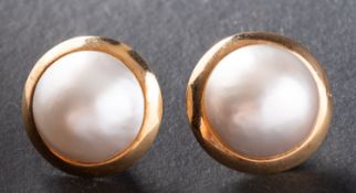 A pair of mabe pearl ear studs, the mabe pearls of white hue with pinkish overtones,