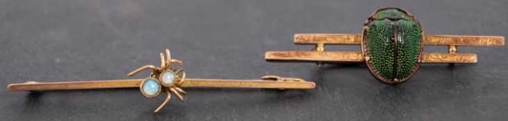 Two bar brooches, including an opal set spider brooch, stamped '9CT', and an enamel scarab brooch,
