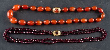 Two bead necklaces, including a graduated, orange/red amber bead necklace, length of beads ca. 1.