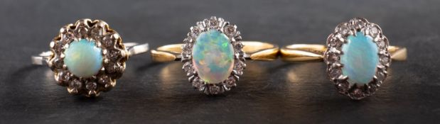 Three cabochon-cut opal and diamond cluster rings, including an 18ct gold ring,