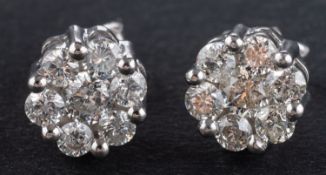 A pair of round, brilliant-cut diamond cluster ear studs, total estimated diamond weight ca. 0.