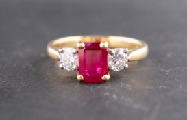 An 18ct gold, octagonal, step-cut synthetic ruby and round, brilliant-cut diamond three-stone ring,