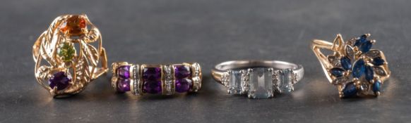 Four gemset rings including an aquamarine and diamond ring stamped '9K';