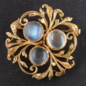 A tripartite, openwork brooch, set with round, cabochon-cut moonstones, with foliate motifs,