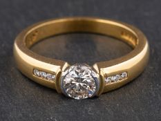 An 18ct gold, round, brilliant-cut diamond ring, estimated weight of principal diamond ca. 0.