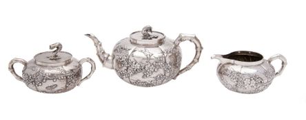A Chinese silver three piece tea service, early 20th century, maker Wang Hing, Hong Kong,
