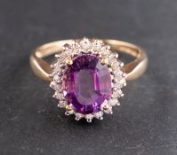 A 9ct gold, oval, mixed-cut amethyst and single-cut diamond cluster ring,