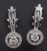 A pair of Ukrainian round, brilliant-cut diamond earrings,