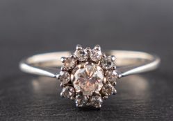 A round, brilliant and single-cut diamond cluster ring, estimated weight of principal diamond ca. 0.