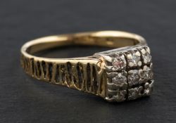 A round, brilliant-cut diamond cluster ring, of square design, total estimated diamond weight ca. 0.