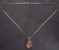 An openwork floral spray garnet pendant, with partial import marks for London,