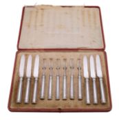 A set of twelve George V silver fruit knives and forks, maker Thomas Bradbury and Son, Sheffield,
