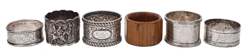 Five silver napkin rings, to include a Chinese white metal napkin ring of a procession,