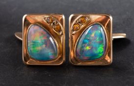 A pair of opal doublet cufflinks, with probably topaz highlights, stamped '9CT',