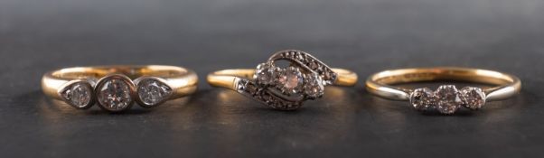 Three diamond three-stone rings, including an 18ct gold ring, total estimated diamond weight ca. 0.