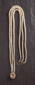 A triple-rowed, graduated, cultured pearl necklace with 9ct gold clasp set with an amethyst,