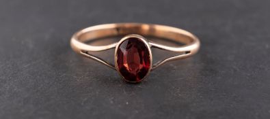 An oval, mixed-cut garnet ring, estimated garnet weight ca. 0.