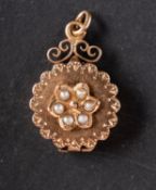 A locket pendant, with seed pearl floral motif, hinged front cover and two inner compartments,