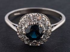 A round, mixed-cut sapphire and single-cut diamond cluster ring, estimated sapphire weight ca. 1.