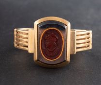 A hemitate and carnelian intaglio ring, depicting the bust of a Greek warrior in profile,