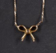 A serpentine-link chain, with a bow frontispiece, stamped '14K', total length ca. 38.