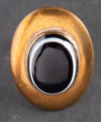 An oval, cabochon-cut, sardonyx ring, stamped '9CT', length of ring head ca. 3.
